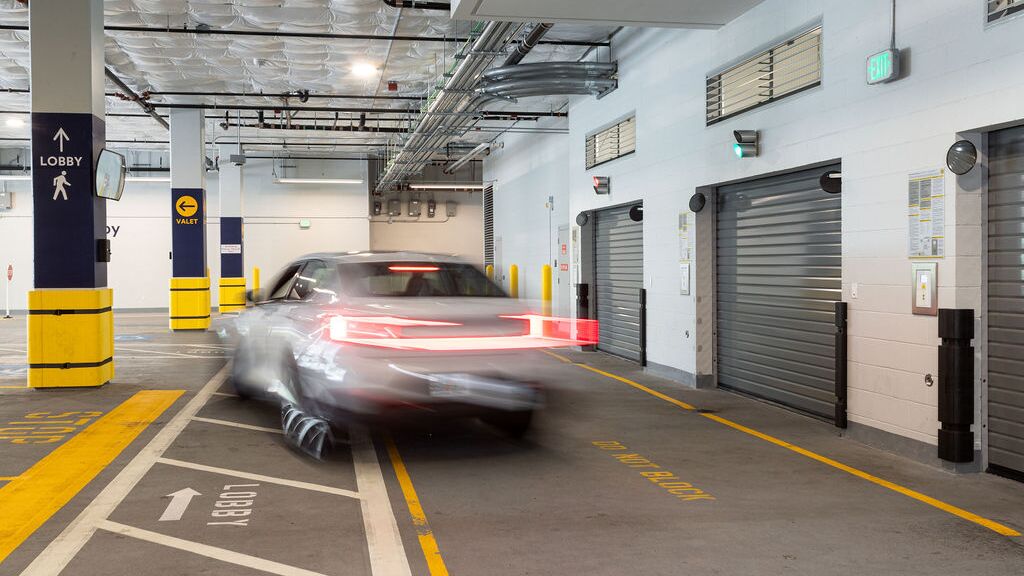 Das Bild zeigt die Einfahrt eines automatisierten Parksystems in einer modernen Tiefgarage mit mehreren Zugangstoren.