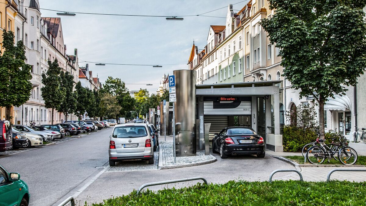 The car drives through an entrance gate